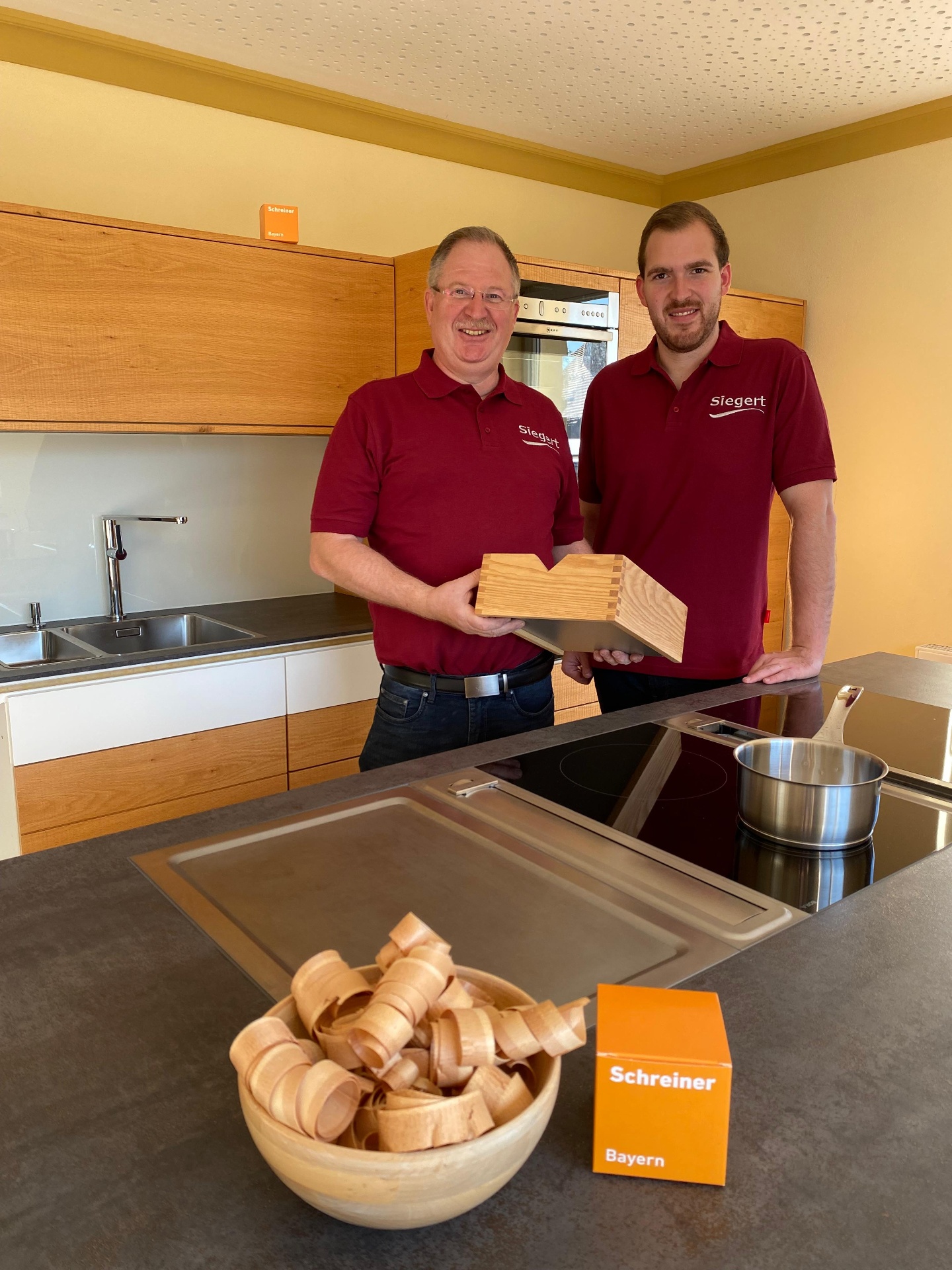 Reinhard und Martin Siegert in der Schauküche mit handgefertigter Zinkenverbindung